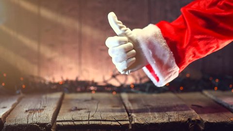 Santa Claus hand Thumb up gesture over Christmas holiday wooden rural background. Beautiful Empty Christmas room with garland. New Year Background.  Xmas. Thumbup. 3840X2160 4K UHD video footage