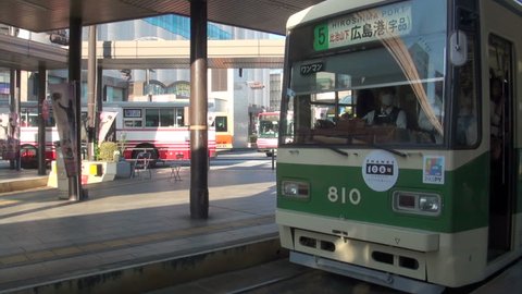 HIROSHIMA, JAPAN - 29 OCTOBER 2012: A classic streetcar is leaving the platform of the Hiroshima train station in Japan