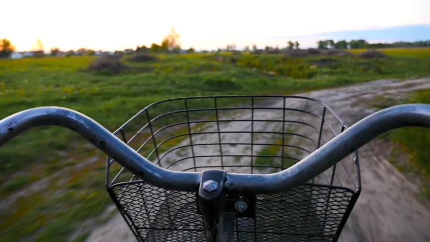 Riding a bike along the beautiful rural road. Evening, sunset