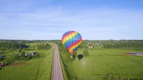 aerial video of  bright aerostat over road on sunny day