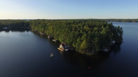 aerial beautiful cottages on lake muskoka reverse flight scenery