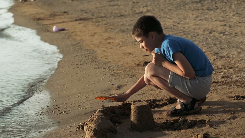 Child building a sand castle on the beach