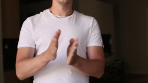 Male hands clapping on black
