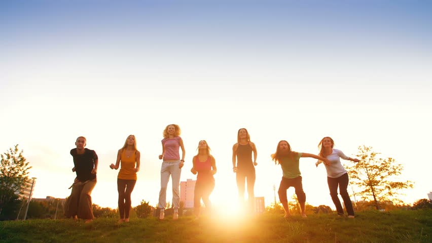 People Jumping at Sunset