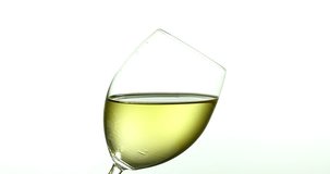 Drop of White Wine falling into Glass, against White Background, Slow motion 4K