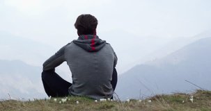 Athlete man runner resting sitted.Real people adult trail running sport training in autumn or winter in wild mountain outdoors nature, bad foggy weather.4k video