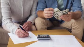 family, savings, old age and people concept - smiling senior couple with money, bills and calculator at home - Powered by Shutterstock - Get 15% off with code: PIKWIZARD15