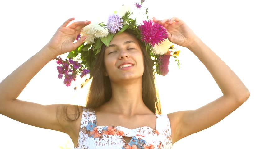 beautiful girl in a wreath of flowers. high speed camera shot. full HD 1080p.