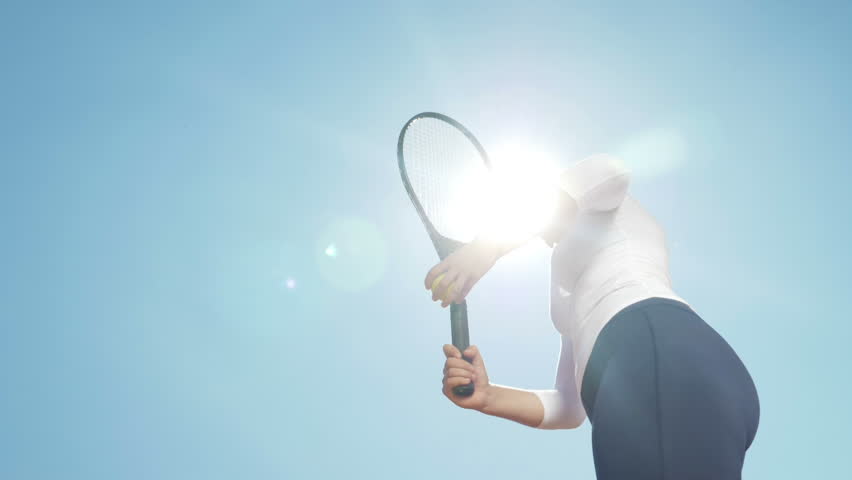 Beautiful young girl tennis player woman serving ball with racket outdoor with sun behind her