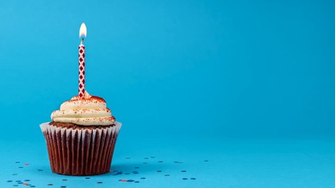 Cupcake party with candle on blue background cinemagraph seamless loop.