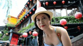 charming travel Asian girl like visiting famous landmark of Taipei Taiwan and using live video inviting her friends to come and have fun.