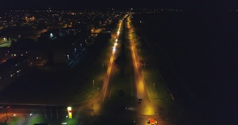 Camera follows cars, on the road at night. Aerial footage. An amazing aerial view of Kohtla-Jarve City at night, Estonia.