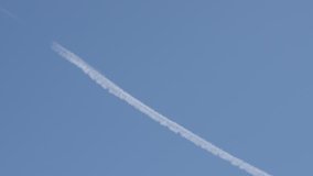 Blue sky and water-based contrails from engine exhaust  3840X2160 UHD footage - Spreading of chemtrails behind aircraft 3840X2160 UltraHD video