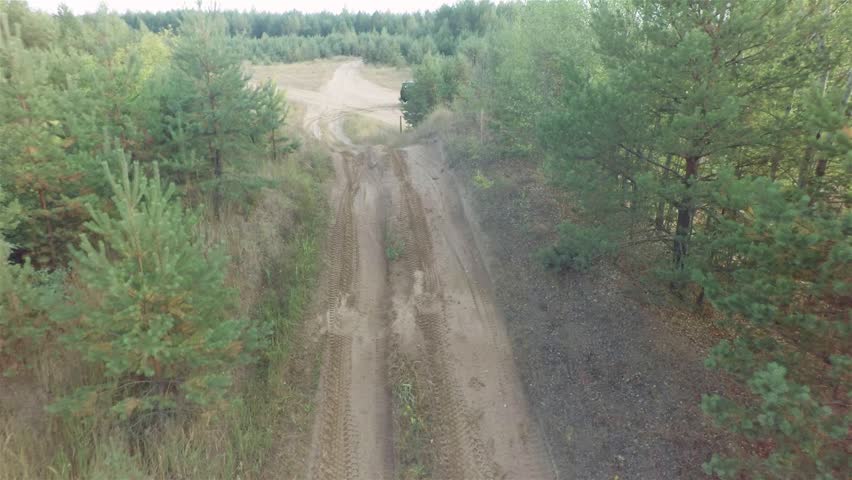 The Off Road Truck Is Driving Through The Forest. Aerial Shot.