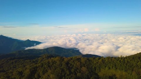 Aerial drone shot over the Morning fog in dense tropical rain-forest, Misty mountain forest fog
