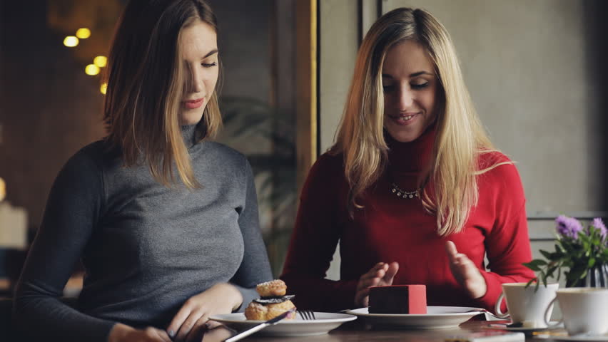 Women friends enjoy, eating cakes in cafe Royalty-Free Stock Footage #31883326