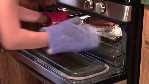 Removing cooked pumpkin pie from oven : vidéo de stock