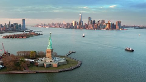 Aerial view of the Statue of Liberty at dusk. Manhattan and New Jersey skyline. New York City, United States. Shot from a helicopter.