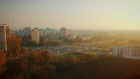 Beautiful cinematic aerial shot of misty sunrise in foggy town in autumn