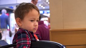 Cute Little Boy Eating a Croissant in a Restaurant - 4k Video