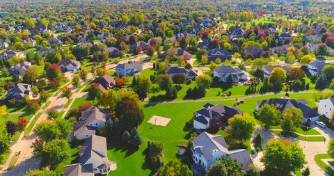 Beautiful neighborhoods, homes amid Autumn colors, aerial view.
