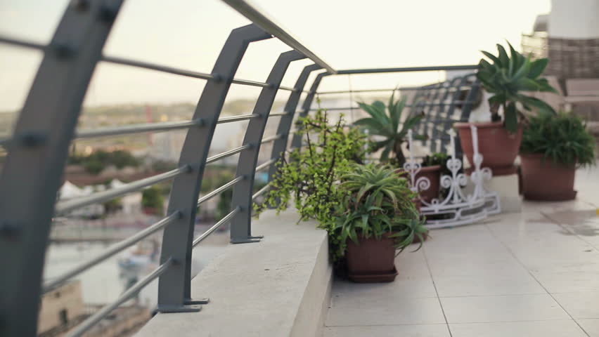 Young tired, frustrated businessman resting on terrace, crane shot

