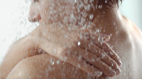 woman taking a shower in slow motion, beautiful girl washing and enjoy herself under a shower, close up of the hands, shoulder and back