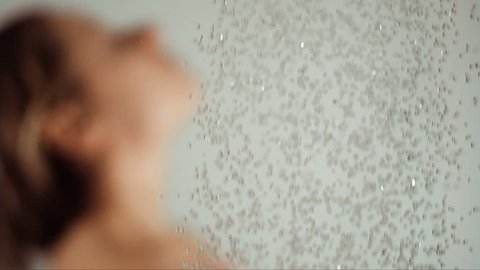 woman taking a shower in slow motion, beautiful girl washing and enjoy herself under a shower, close up of the hands, shoulder and back