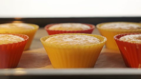 Baking sheet with muffins in hot oven timelapse. View from inside of the oven. Making homemade muffins cupcakes baked in oven. Quick sweet dessert for breakfast. Using colorful silicone baking molds. स्टॉक वीडियो