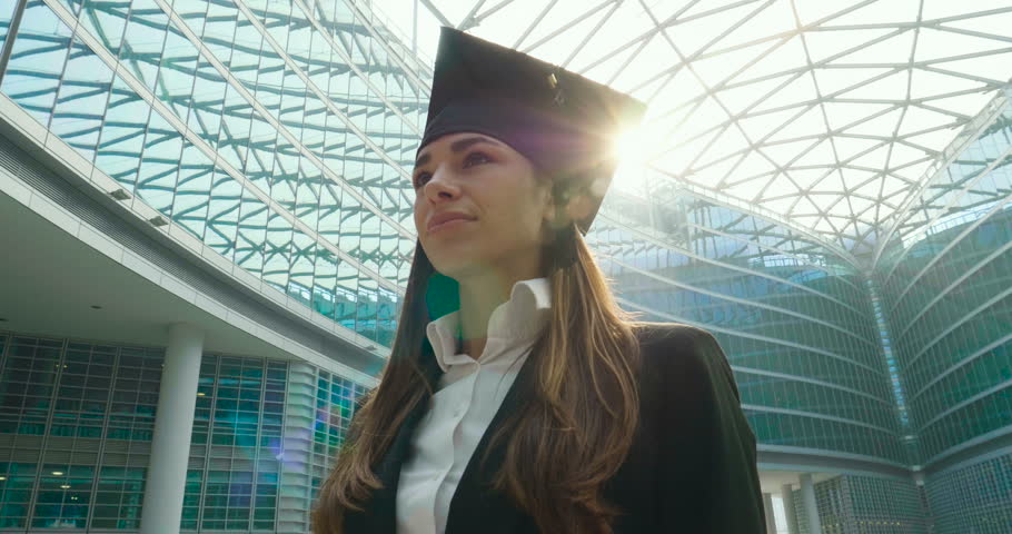 A newly graduated woman in the economy, look to the future with the proud and sure look of her for the result she just got.  Royalty-Free Stock Footage #31906339
