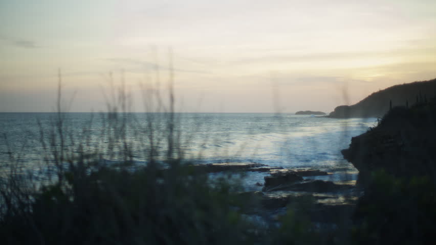 Evening on ocean shore. Sunset with waves, rocks and ocean. Sunset landscape in Popyo, Nicaragua, Central America