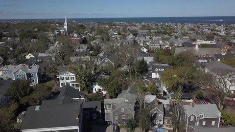 Nantucket Historic Village close AERIAL. Nantucket, a tiny, isolated island off Cape Cod, Massachusetts, is a summer destination with beaches. It’s marked by unpainted cedar-shingled buildings