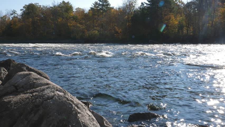 View from shore of fall freshwater river. Autumn in Young