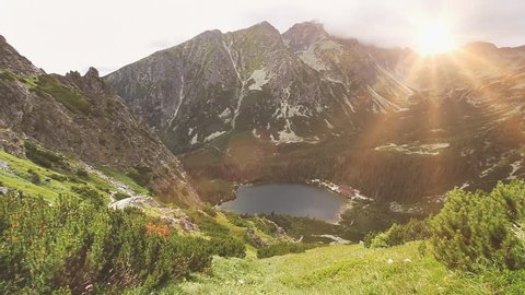 Tatry mountains in Poland. Panorama of mountain range, lake and green grass motion on wind. Summer nature landscape. Beauty world, sport lifestyle, holidays, travel and recreation. Full HD