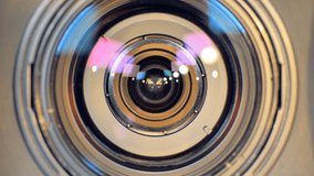 A macro view on a camera lens and a zoom button. 