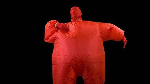 a man inside a red inflated fat suit dancing