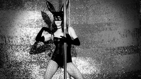 amazing pole dancer moving in a costume with bunny ears