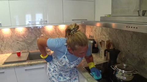 Obsessive woman cleaning the kitchen