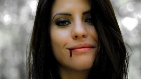 Vampire woman smiling with blood