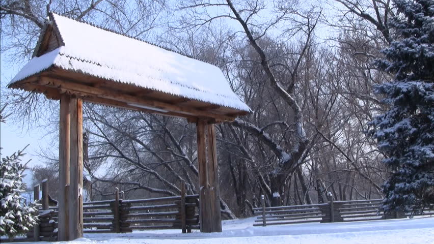 Panning shot of footstep trail in snow in winter park