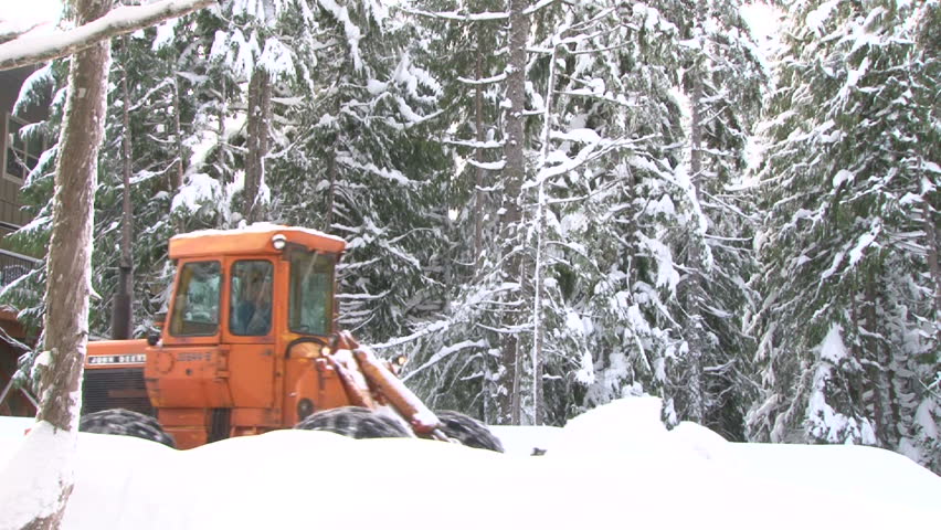 GOVERNMENT CAMP, OREGON - CIRCA 2012: Large tractor snow plowing roads after