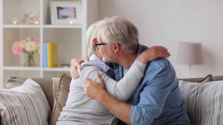 Relationships, old age and people concept - sad senior couple hugging at home | Shutterstock HD Video #31947946