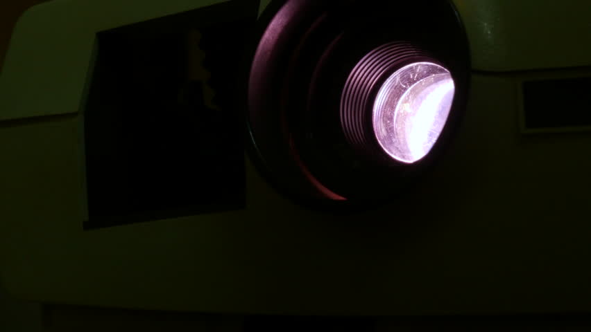  old Photo slide projector close up of the lens changing color and flashing light shot in 4 k