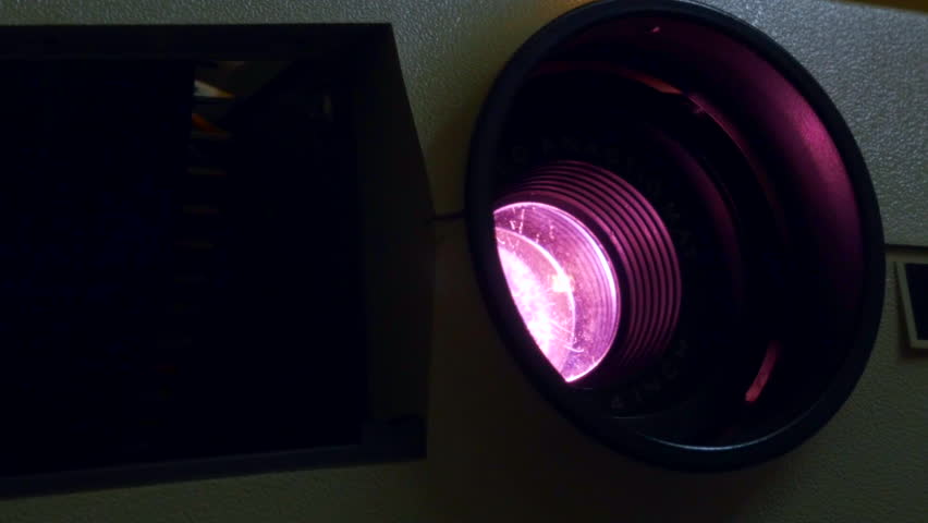  old Photo slide projector close up of the lens changing color and flashing light shot in 4 k