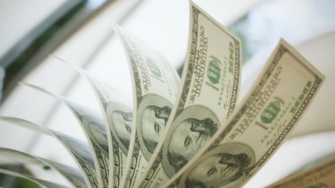 Close-up shot of counting 100 dolar bills