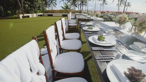 luxurious decoration of wedding table with plates,cultery and cups on the background of tropical nature of resort hyatt on island maui,hawaii