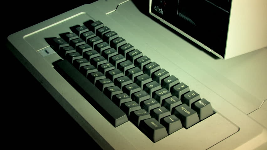 Typing on an old-style computer.