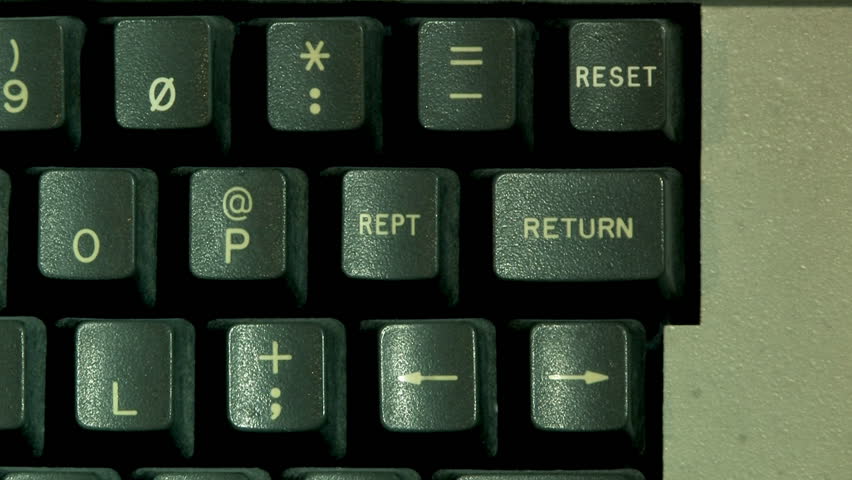Hitting the RETURN key on an old-style computer.