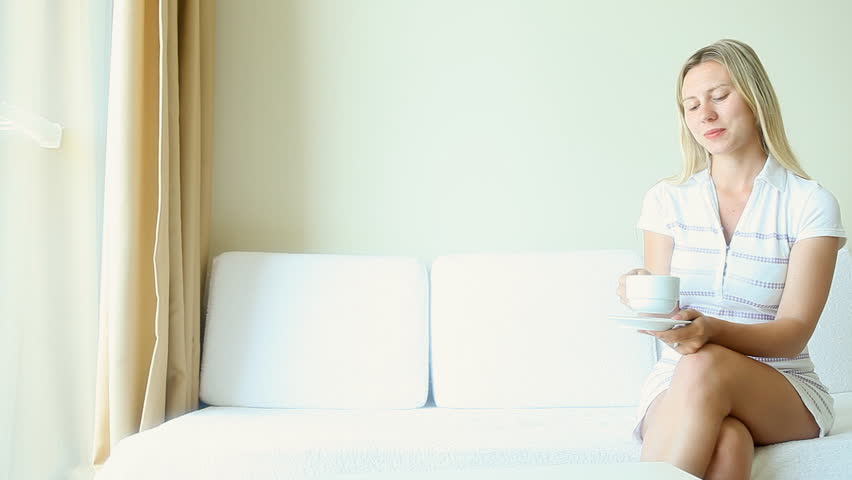 girl in a hotel room drinking coffee