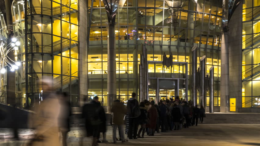 The queue of people at the entrance to a music concert in modern concert hall, time lapse
